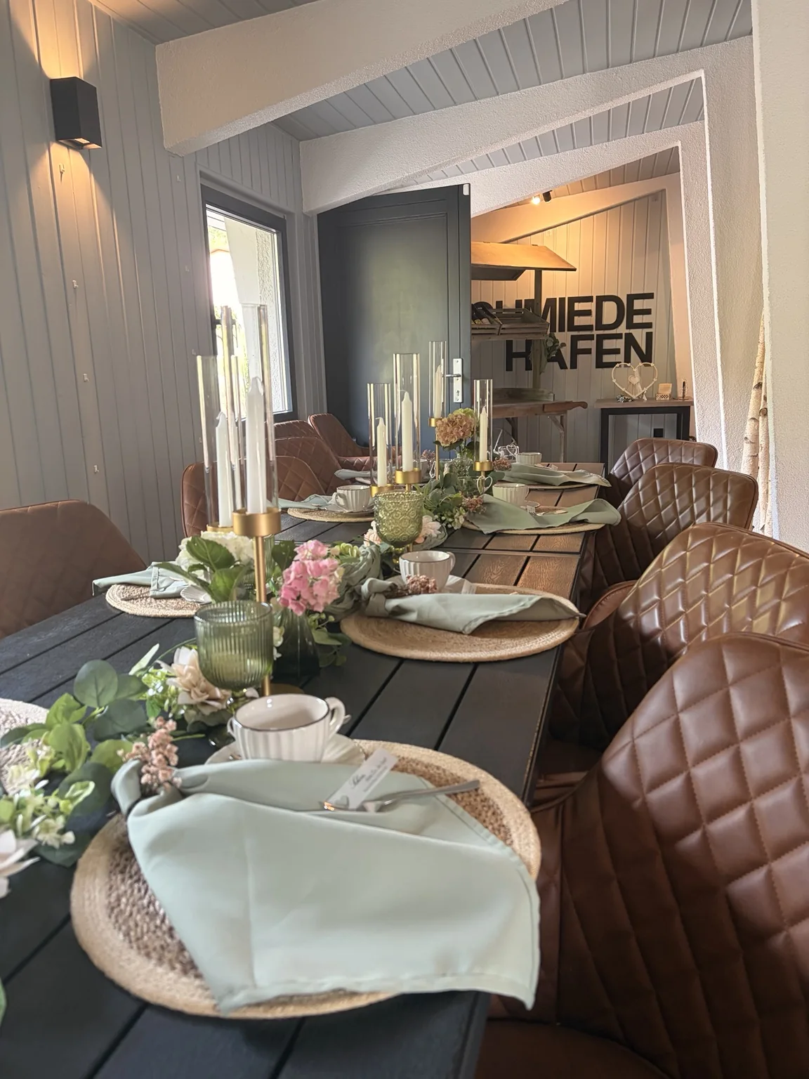 Liebevoll gedeckte Tafel mit Blumen und Porzellan im Schmiedehafen