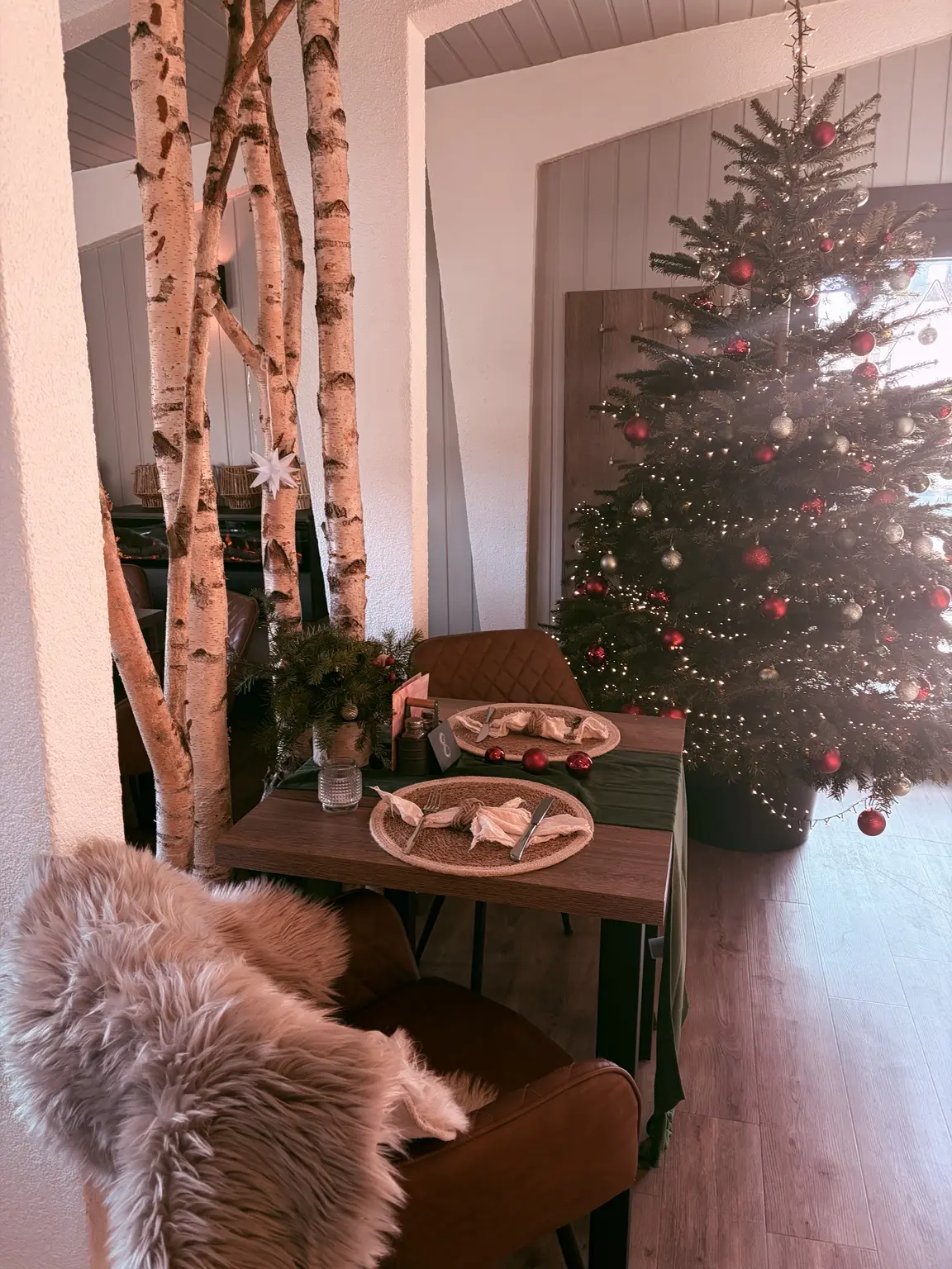 Weihnachtsbaum und gedeckter Tisch zwischen Birkenstämmen im Schmiedehafen